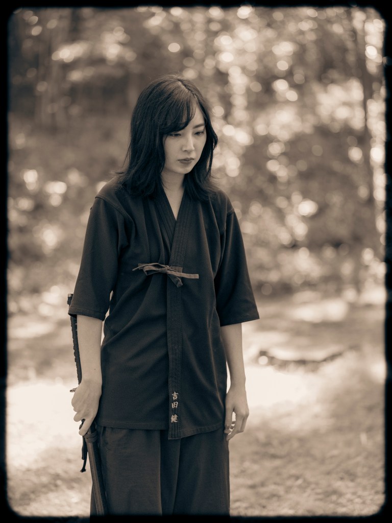 The armor gives way to a simple black keikogi, a martial arts training uniform.