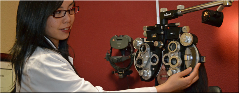 An optometrist adjusting a phoropter while performing a comprehensive vision and prescription lens exam for a patient at Optima Optometry in Santa Clara California.
